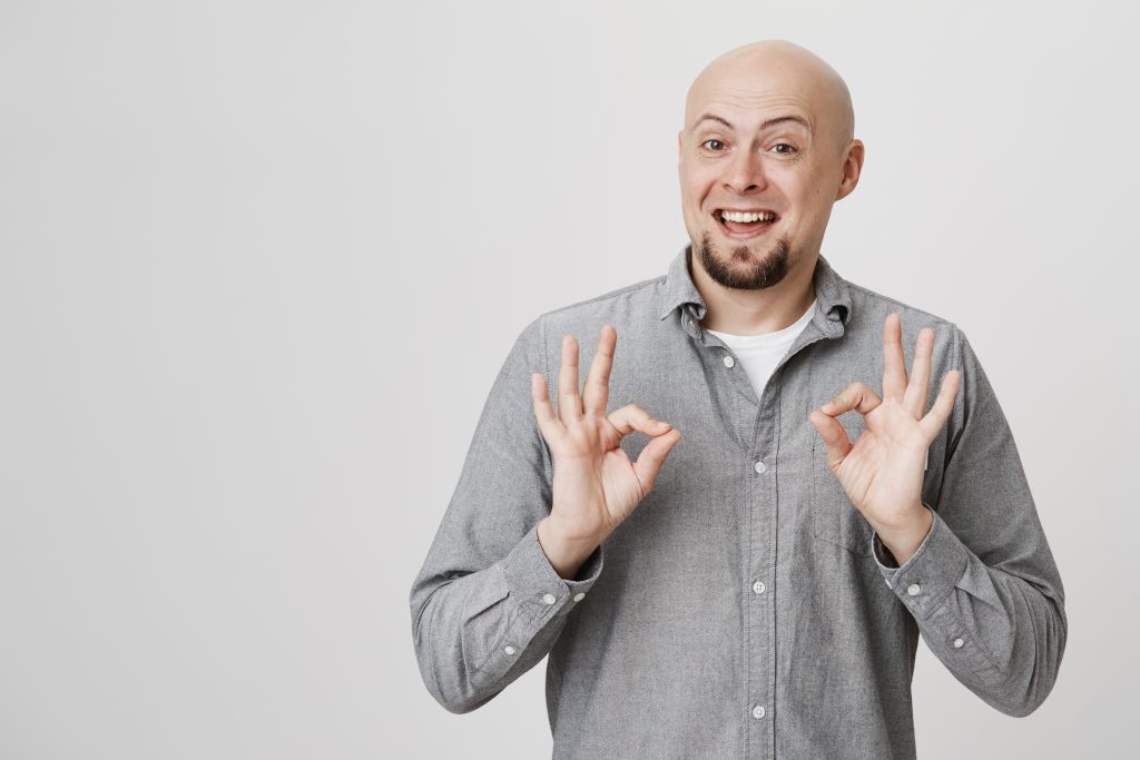 Bald man happy with moisturizer