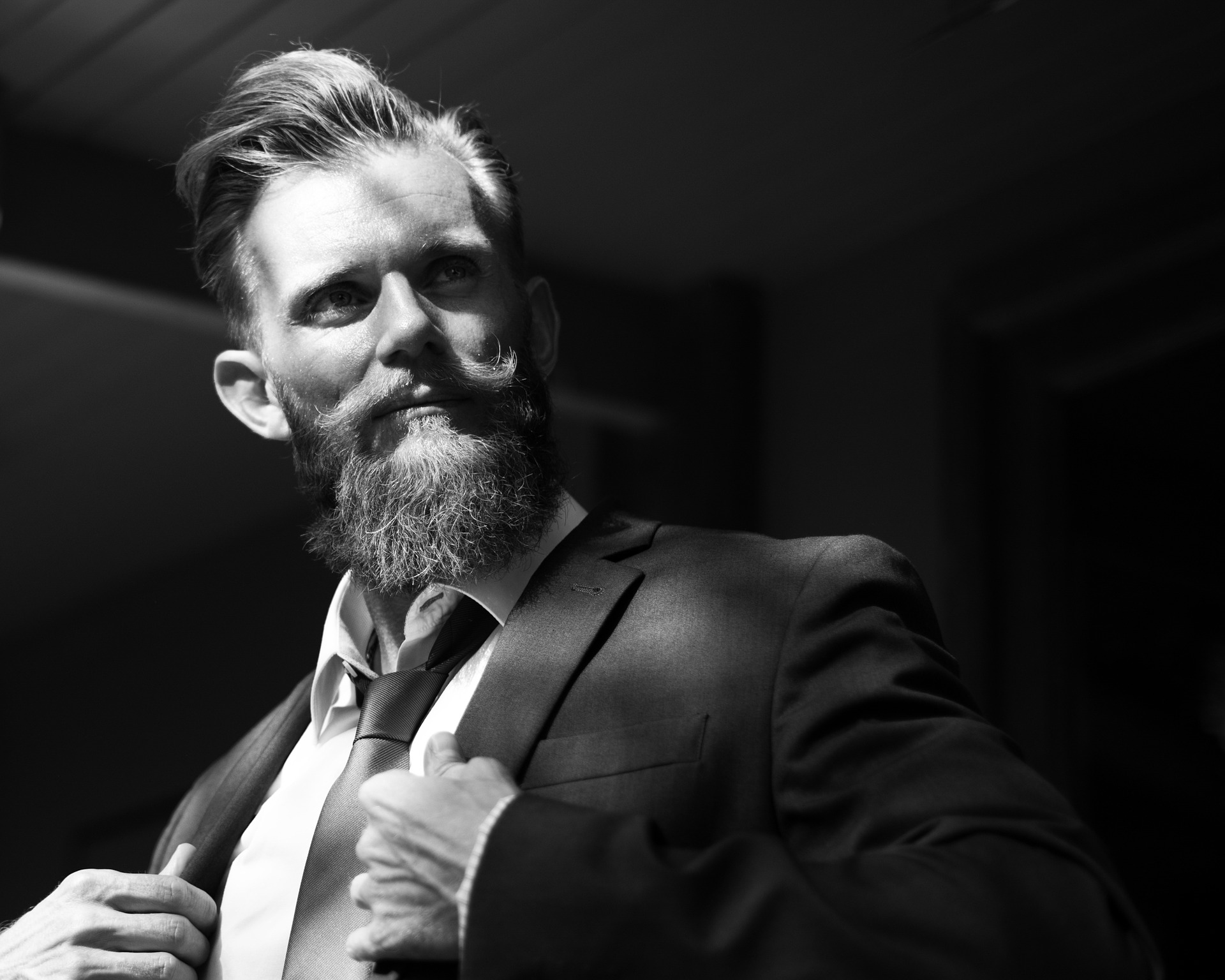 Man wearing a business attire has a long beautiful beard