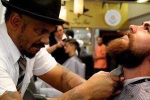 man having his beard trimmed