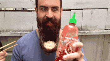 Man eating noodles on his beard