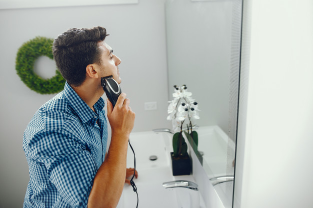 man shaving moustache