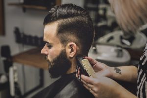 man having his hair trimmed in a barbershop