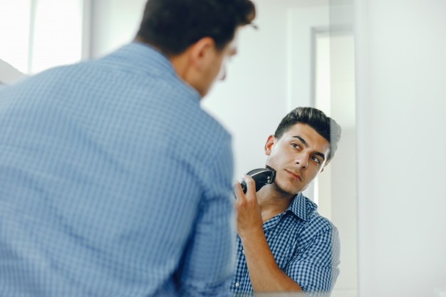 man shaving his face